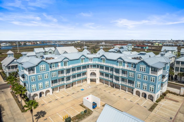 Aerial view of the blue condominium building at 137 Palmilla Circle, Palmilla Beach