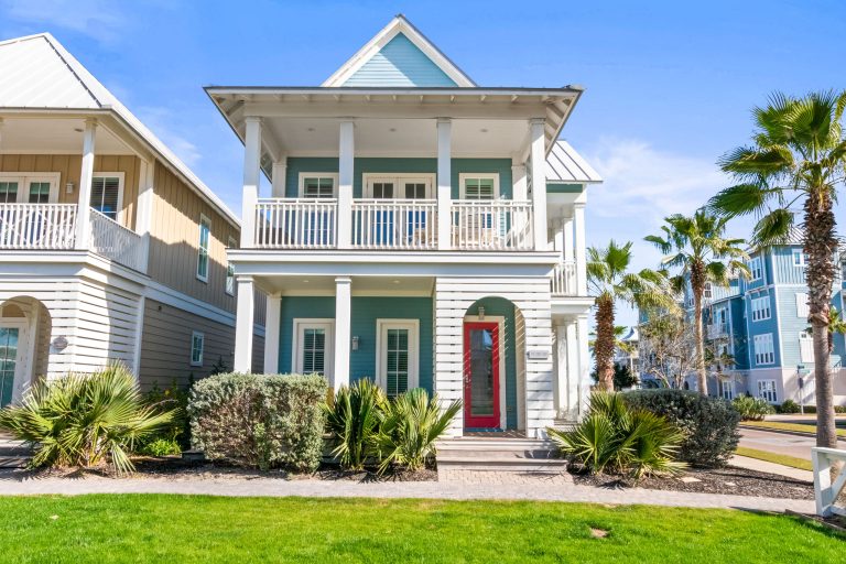 Front of 152 Sea Rocket Lane, a two-story aqua single-family home at Palmilla Beach