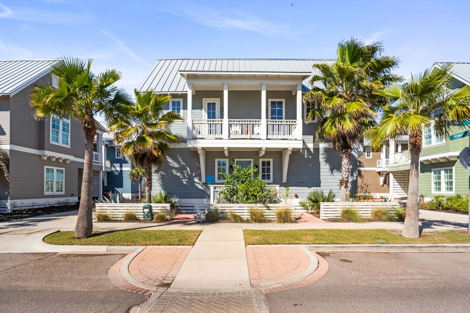 Front of 200 Sunset Avenue, a two-story single-family home with palm trees at Palmilla Beach