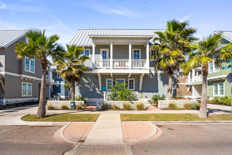 Front of 200 Sunset Avenue, a two-story single-family home with palm trees at Palmilla Beach
