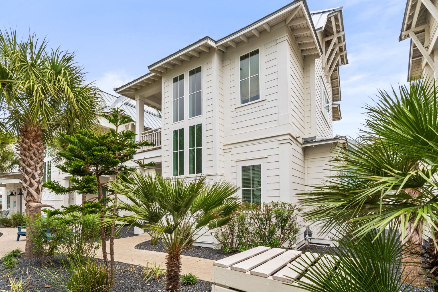 Exterior of the white casita building at 214 Sunset Avenue #5 with palms