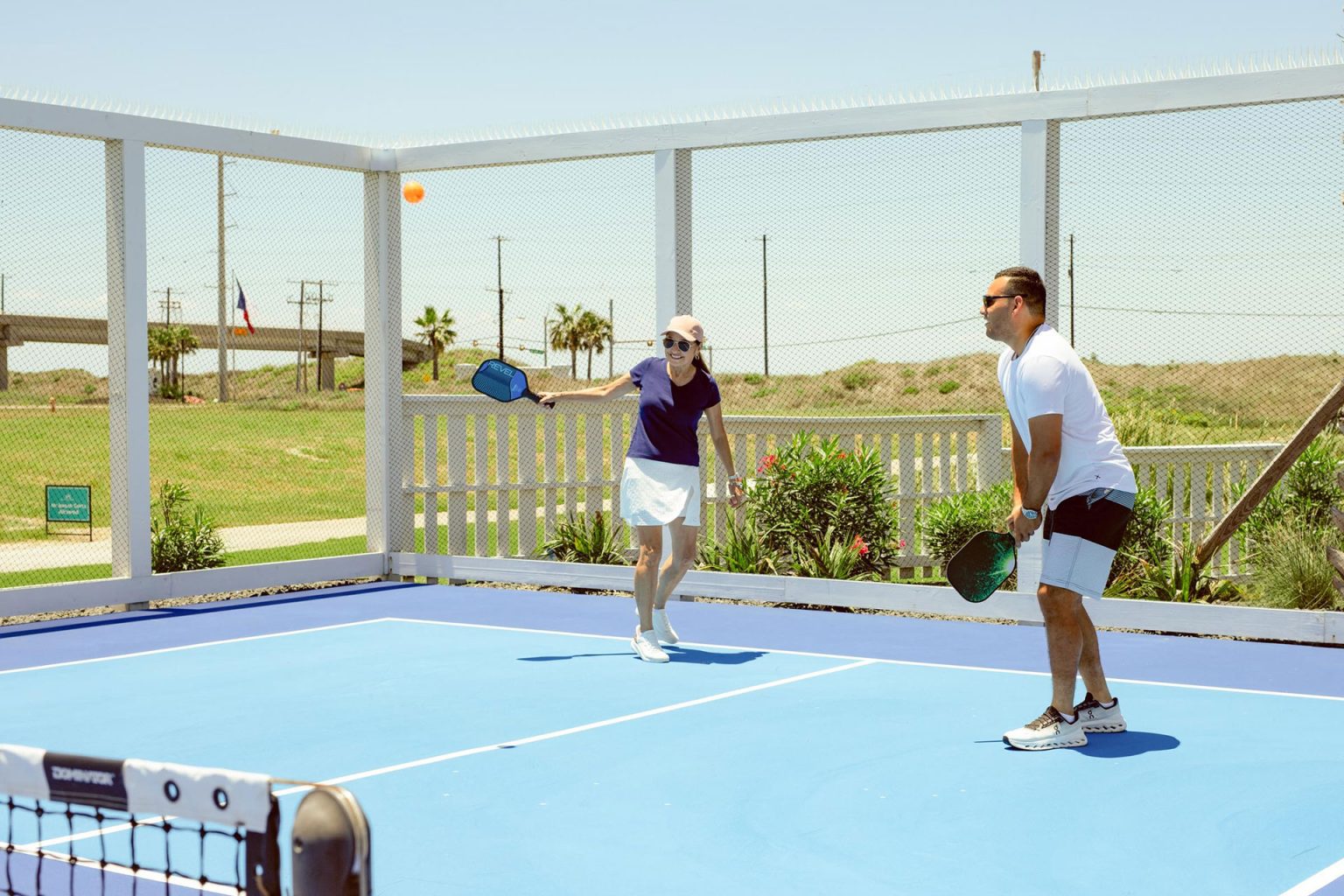 Couple playing pickleball at The Oasis