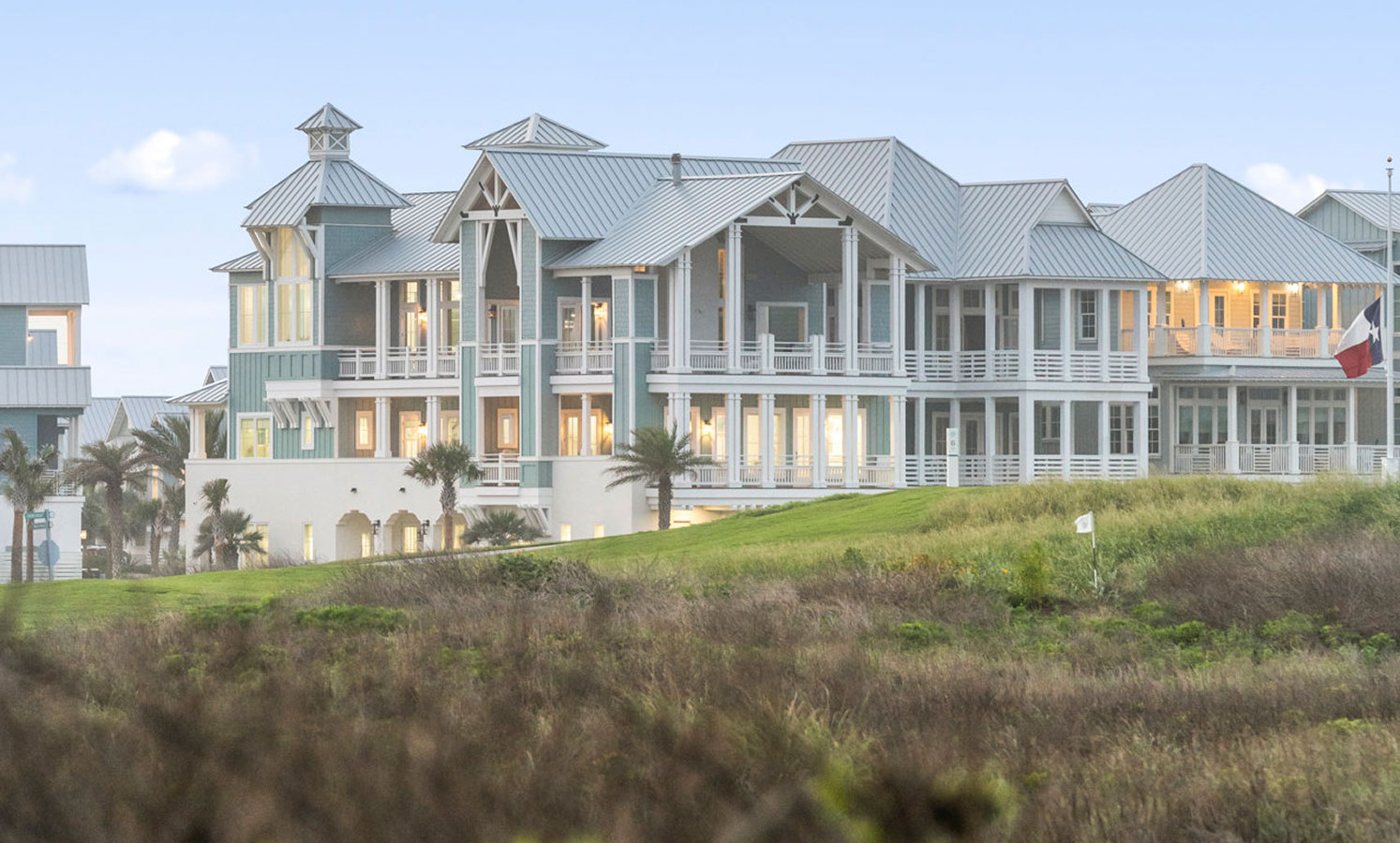 Large beach homes above the grassy dunes at Palmilla Beach