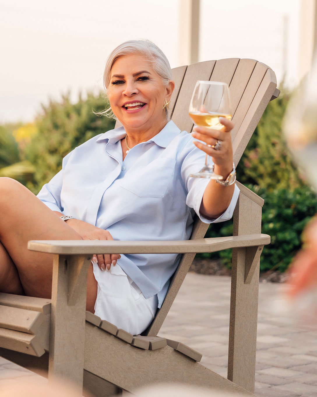 Woman relaxing with a glass of wine on a Palmilla Beach porch