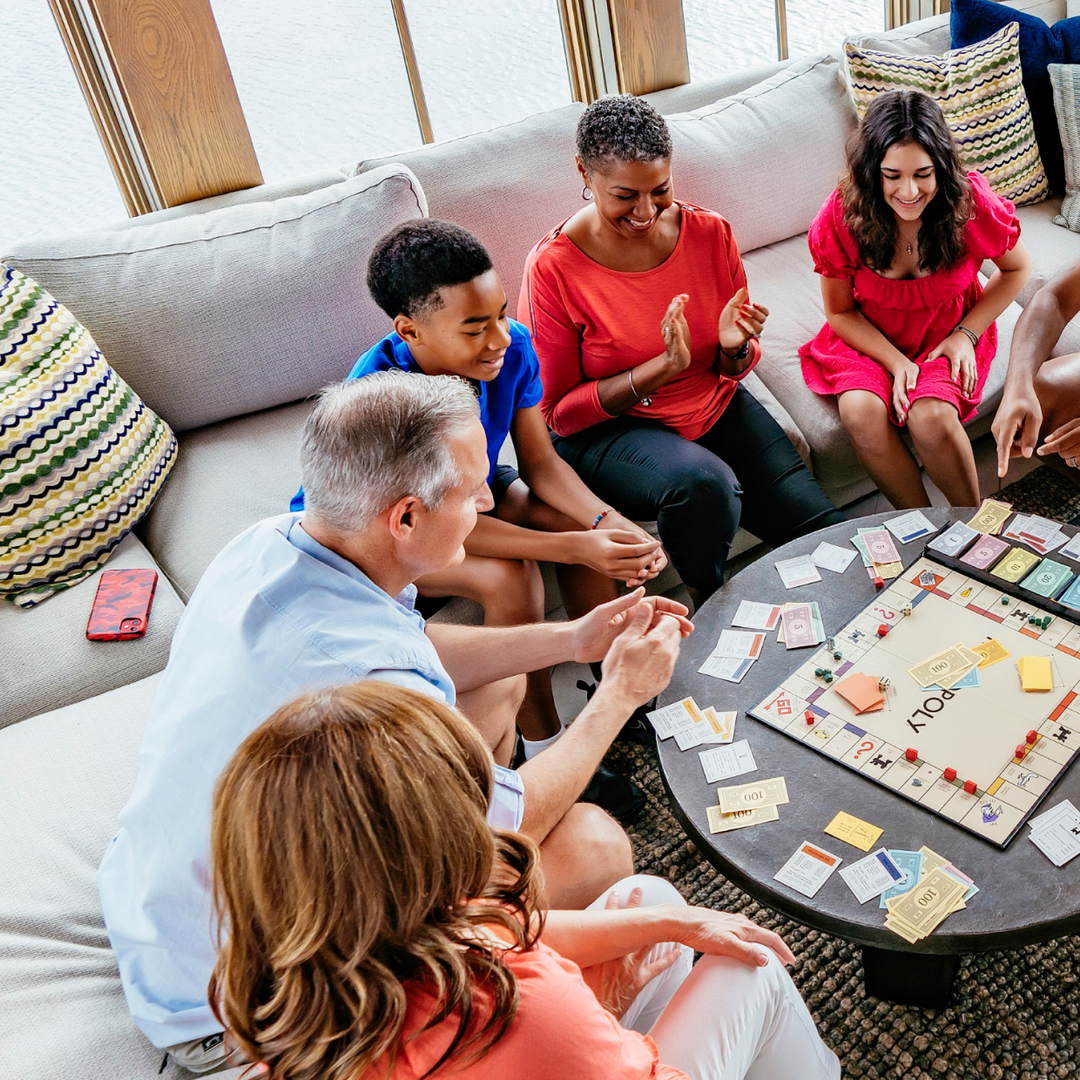 Family playing a board game together in a Palmilla Beach vacation home