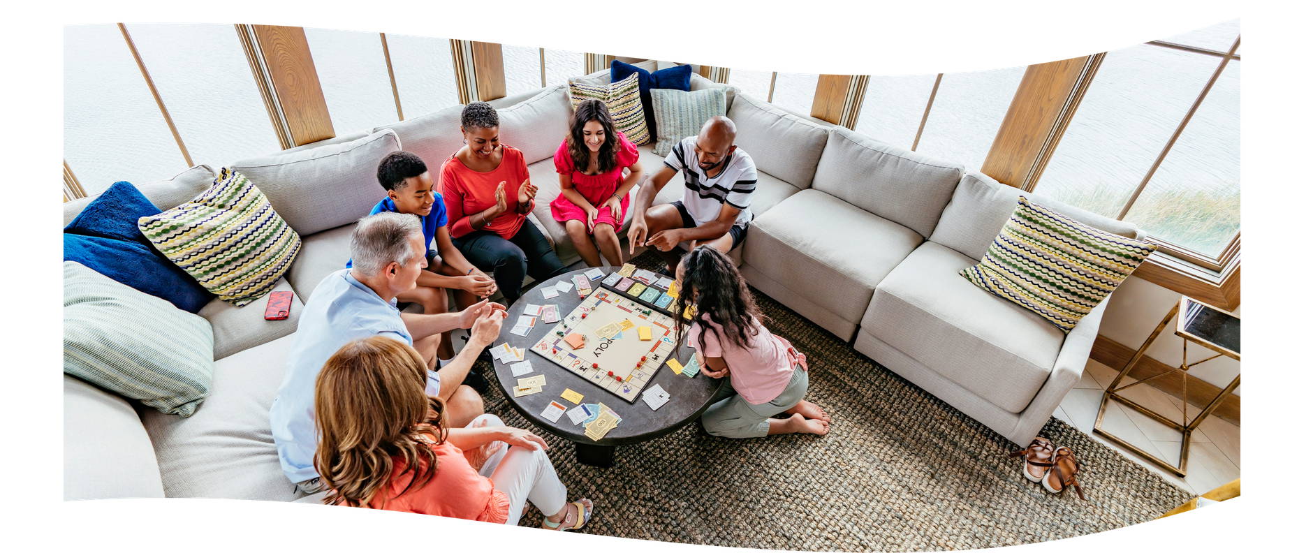 Family playing a board game together in a Palmilla Beach vacation home