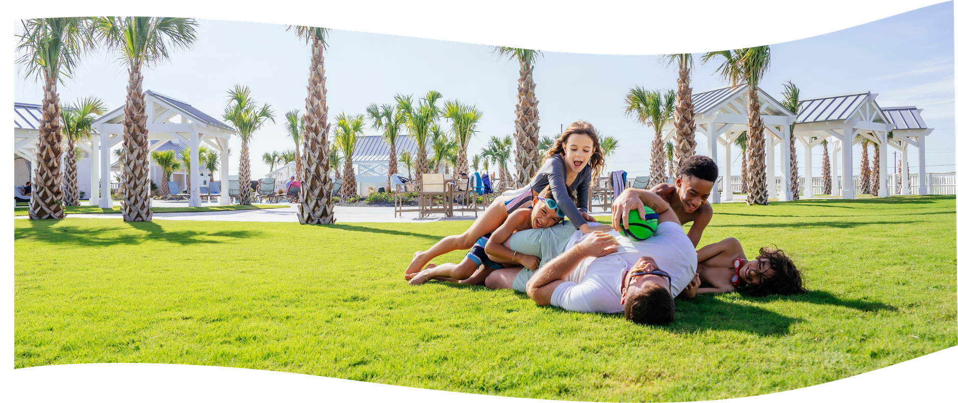 Family playing together on the lawn at Palmilla Beach