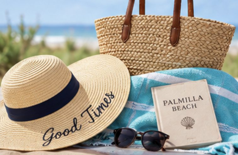Sun hat, sunglasses and a Palmilla Beach book on a beach towel